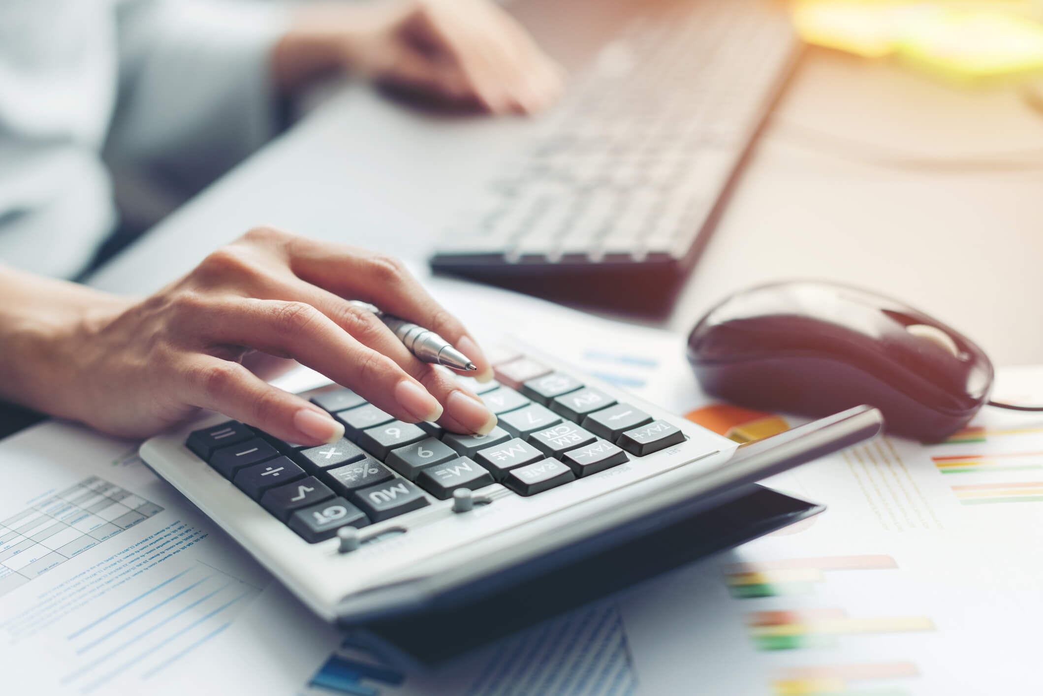 Professional using calculator to check figures